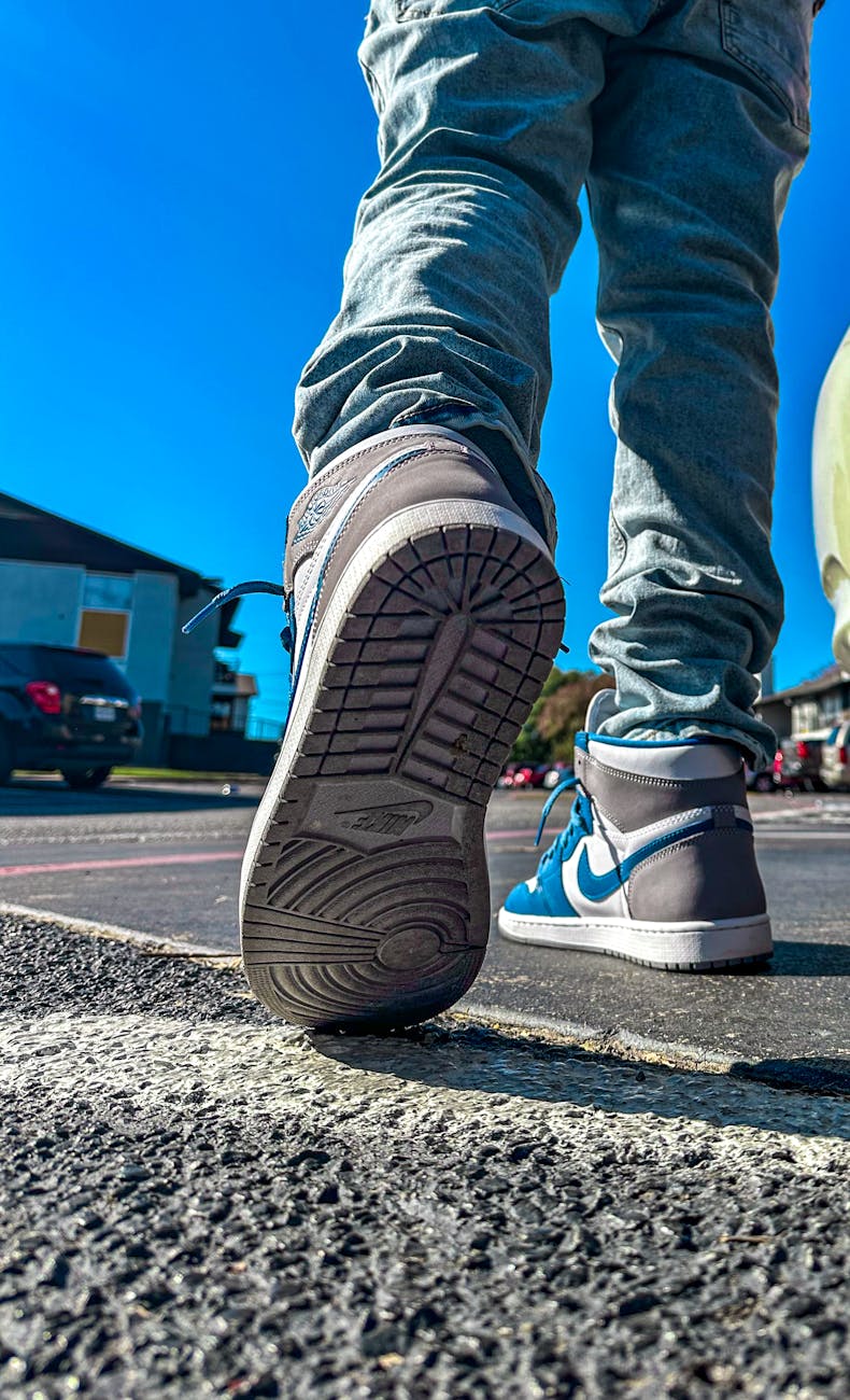 close up of stylish sneakers on city street