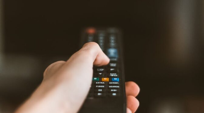 hand with remote control