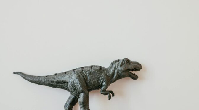 plastic dinosaur over white surface